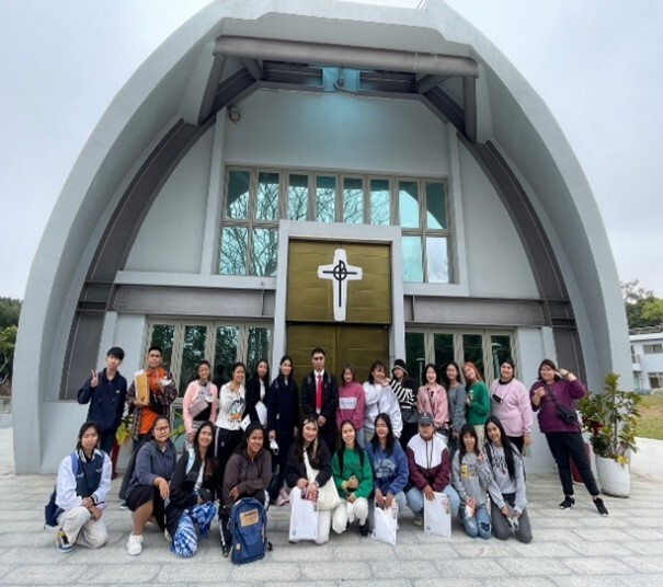 Taking a group photo in front of our lady of providence chapel during the campus tour